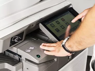 Man using software on colour printer