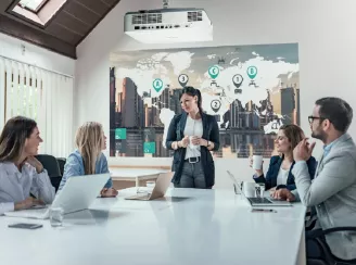 A team in a meeting using a projector