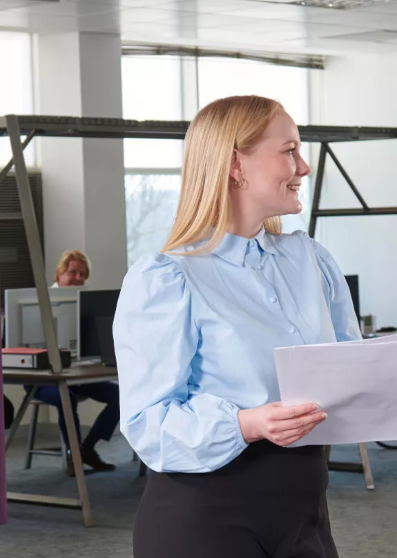 Colleagues talking at office printer