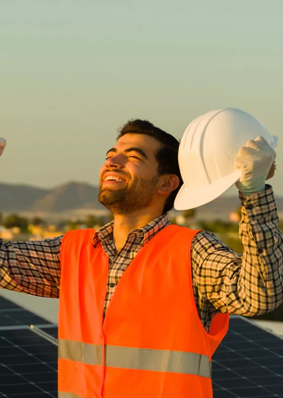 Happy Solar Professional Holds Fists Up